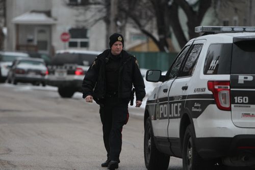 Winnipeg Police vehicles block streets surrounding Alexander Ave and Fountain Street Saturday where it is believed a shooting took place earlier in the day.  A women arrested at the scene.    April 14  2014 Ruth Bonneville / Winnipeg Free Press