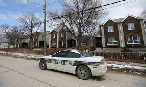 Winnipeg Police at the scene of Saturdays shooting that claimed the life of Geoffrey Oliver Reid, on the 300 block of Alexander Avenue, Sunday, April 13, 2014. (TREVOR HAGAN/WINNIPEG FREE PRESS)