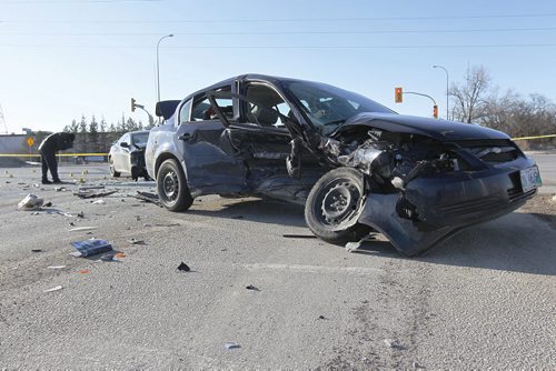April 13, 2014 - 140413  -  Forensics officer works a scene of a serious MVC at the intersection of St Anne's Rd and Bishop Grandin Blvd Sunday, April 13, 2014. John Woods / Winnipeg Free Press