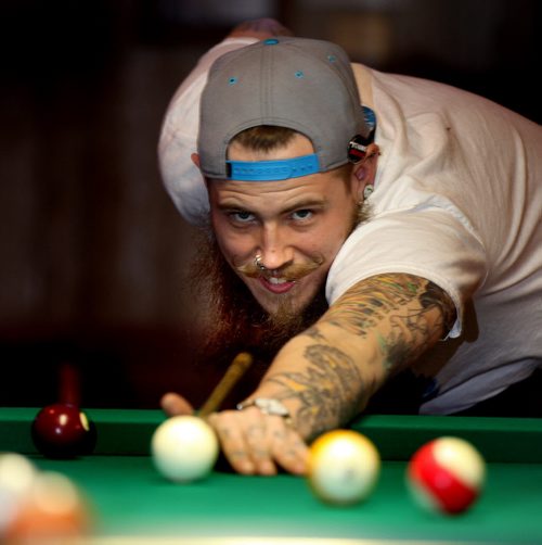 Justin Ross takes aim at a billiard table during an evening meeting of the Manitoba Facial Hair Club. See Dave Sanderson story. April 14, 2014 - (Phil Hossack / Winnipeg Free Press)