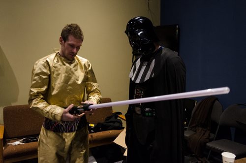 Graham Hunt, half dressed as C-3PO, works with Stephen Ashcroft, dressed as Darth Vader, to figure out how to turn on the lightsaber.  The Star Wars themed Easter service is expected to attract between 5-6 thousand spectators this weekend to the Church.  Each year the church takes a different pop culture story and adapts it to tell the story of the resurrection of Jesus Christ.  EMILY CUMMING / WINNIPEG FREE PRESS APRIL 15, 2014