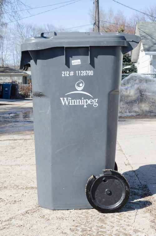 Kevin Rollasons Emterra garbage bin has a damaged wheel.  EMILY CUMMING / WINNIPEG FREE PRESS APRIL 16, 2014