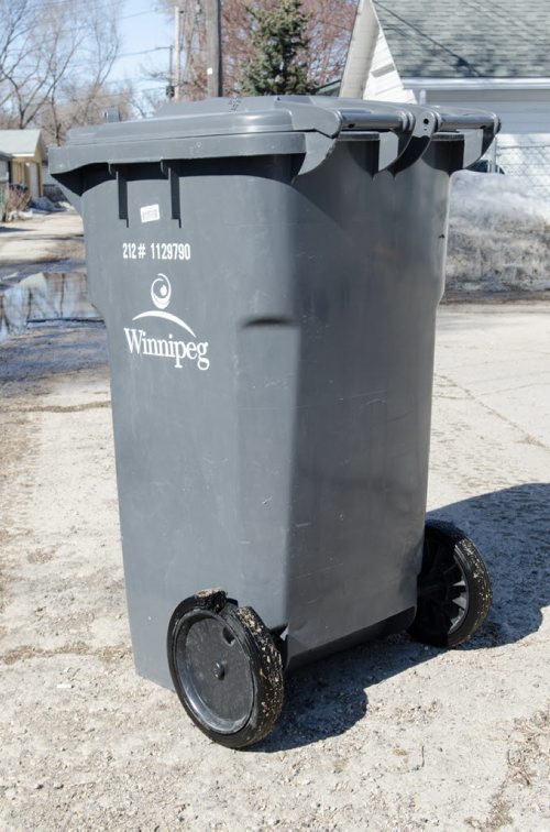 Kevin Rollasons Emterra garbage bin has a damaged wheel.  EMILY CUMMING / WINNIPEG FREE PRESS APRIL 16, 2014