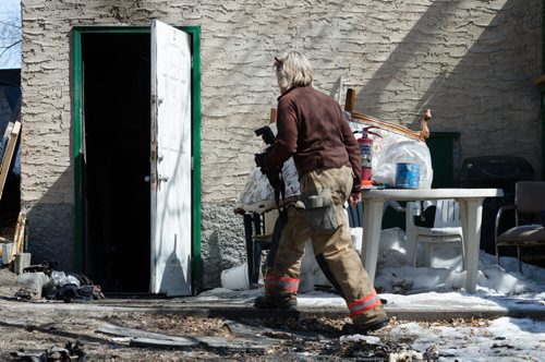 A fire official enters a home on the 300 block of Enfield Crescent near Marion Street to investigate the cause of an early morning fire.  The basement resident died as a result of the fire.  EMILY CUMMING / WINNIPEG FREE PRESS APRIL 16, 2014