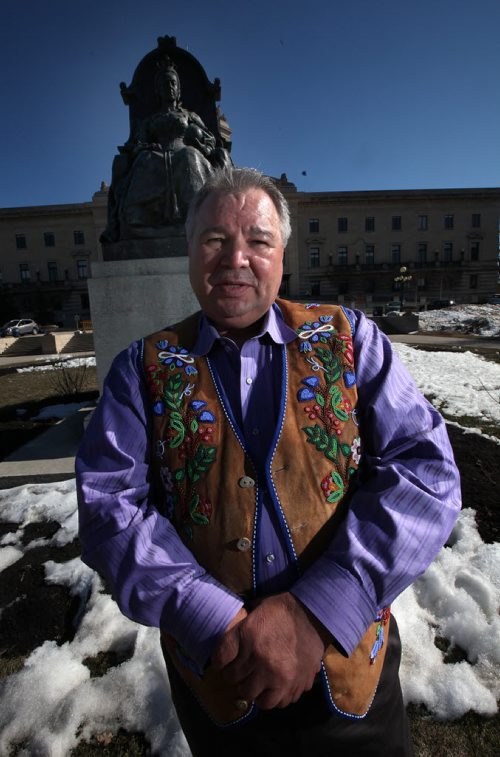Metis leader David Chartrand poses in front of a statue of QWueen VIctoria who ratified the origional BNA act which included the metis.  See story re supremem court decision including them today. April 17, 2015 - (Phil Hossack / Winnipeg Free Press)