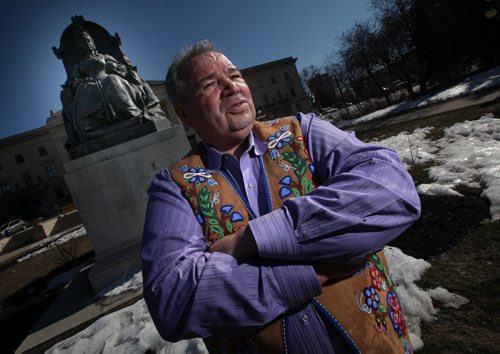 Metis leader David Chartrand poses in front of a statue of QWueen VIctoria who ratified the origional BNA act which included the metis.  See story re supremem court decision including them today. April 17, 2015 - (Phil Hossack / Winnipeg Free Press)