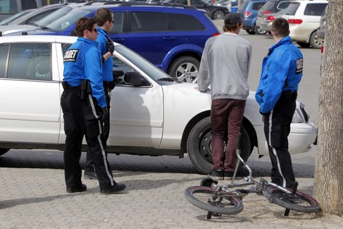 A kid on a bicycle gets ticked for something at the Forks by police cadets. NO OTHER INFO ON THIS INCIDENT.  BORIS MINKEVICH / WINNIPEG FREE PRESS April 18, 2014