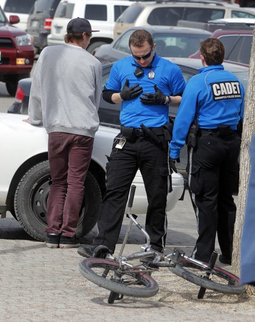 A kid on a bicycle gets ticked for something at the Forks by police cadets. NO OTHER INFO ON THIS INCIDENT.  BORIS MINKEVICH / WINNIPEG FREE PRESS April 18, 2014