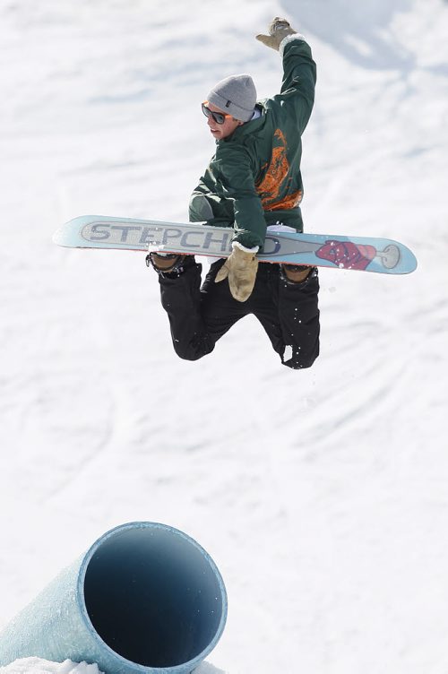 April 18, 2014 - 140418  -  Jeremy Dalman does a  "back one method" as he flies off the tube at Stony Mountain Ski Area Friday, April 18, 2014. This is the last day of boarding at the hill. John Woods / Winnipeg Free Press