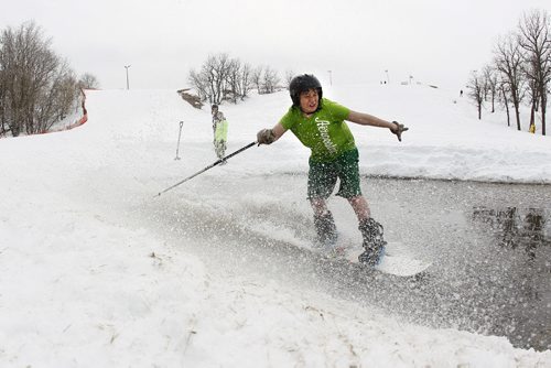 April 18, 2014 - 140418  -  Laine Lecoq blasts through the pond on his snowboard at Stony Mountain Ski Area Friday, April 18, 2014. This is the last day of boarding at the hill.  John Woods / Winnipeg Free Press