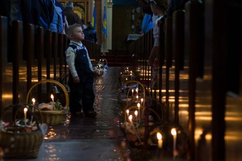 A boy stands in the aisle of Sts. Vladimir & Olga Metropolitan Cathedral.  Parishioners lined the aisles of the Cathedral with Easter baskets for the Blessing of Easter Paska service.  EMILY CUMMING / WINNIPEG FREE PRESS APRIL 19, 2014