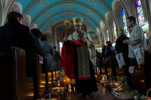 The Priest at Sts. Vladimir & Olga Metropolitan Cathedral blesses the Easter baskets of his parishioners during the Blessing of Easter Paska service.  EMILY CUMMING / WINNIPEG FREE PRESS APRIL 19, 2014