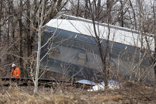 In St.Norbert, CN workers assessing the scene after a section of track appears to have buckled and cars carrying lumber, steel and plastic derailed, Sunday, April 20, 2014. (WINNIPEG FREE PRESS)