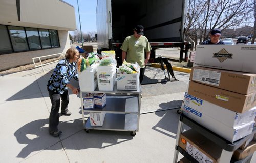 Food is removed and redistributed from of Golden Links Lodge after basement flooding caused a power failure, Sunday, April 20, 2014. 86 residents were evacuated after a disaster protocol was implemented around 3am. (TREVOR HAGAN/WINNIPEG FREE PRESS)