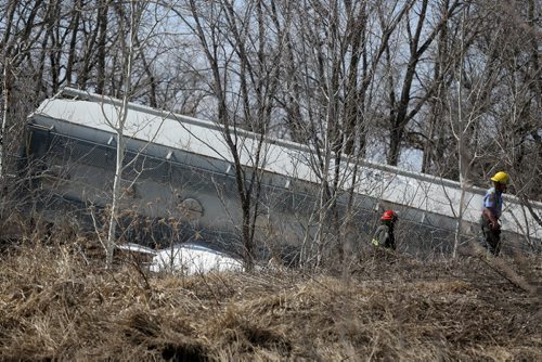 Firefighters at the scene after a few cars derailed on a section of track next to Pembina Highway in St.Norbert, Sunday, April 20, 2014. There were no injuries, and the contents pose no environmental risk. (WINNIPEG FREE PRESS)