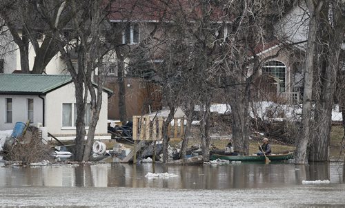 April 20, 2014 - 140420  -  A couple paddles on the swollen Red River Sunday, April 20, 2014. John Woods / Winnipeg Free Press