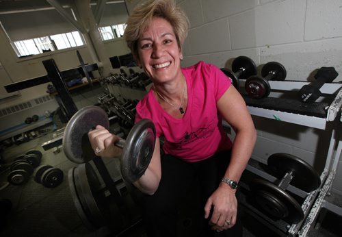 Jill Mathez, Principal at Dakota Collegiate poses in the school's weight room. See Training Basket feature. April 21, 2014 - (Phil Hossack / Winnipeg Free Press)