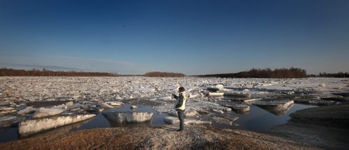 An area resident uses her smart phone to document an ice jam just north of Selkirk Monday evening. See Kevin Rollason story. April 21, 2014 - (Phil Hossack / Winnipeg Free Press)