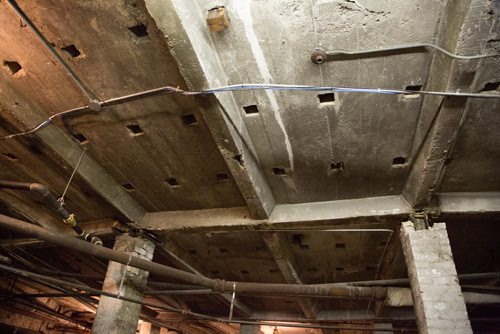 The Burton Cummings Theatre's unfinished basement has holes in the ceiling which were once used as a way of cooling the theatre seating above it in Winnipeg on Friday, March 21, 2014. True North Sports and Entertainment is taking over the management of the theatre and has many necessary upgrades planned. (Photo by Crystal Schick/Winnipeg Free Press)