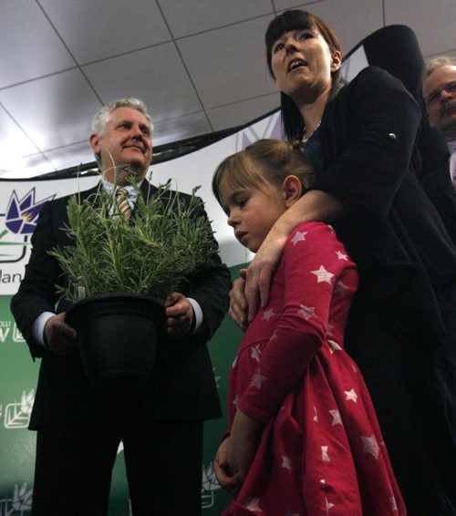 At right, Adrienne Percy, co-founder of Nourished Roots farm along with her daughter Hannah,6, presented Gord Mackintosh, Conservation and Water Stewardship Minister with a pesticide free lavender plant after the news  conference Tuesday where the Minister announced the new rules for the use of pesticides. Bruce Owen story. Wayne Glowacki / Winnipeg Free Press April 22   2014