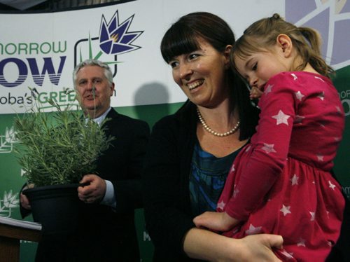 At right, Adrienne Percy is the co-founder of Nourished Roots farm along with her daughter Hannah,6, presented Gord Mackintosh, Conservation and Water Stewardship Minister with a pesticide free lavender plant after the news conference Tuesday where the Minister announced  the new rules for the use of pesticides. Bruce Owen story. Wayne Glowacki / Winnipeg Free Press April 22   2014