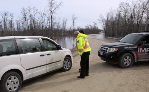 Security guards prevent a vehicle from entering Jenny Drive at  Whitetail Trail in the Petersfield, Mb. area Wednesday morning .  Water levels from Netley Creek caused the evacuation of homes earlier.   Wayne Glowacki / Winnipeg Free Press April 23   2014
