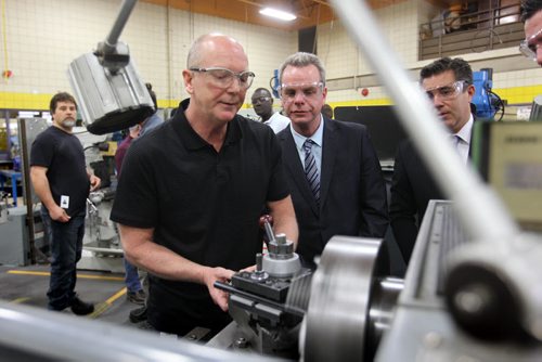 WTC teacher Dan Zvanovec shows Education Minister James Allum (centre) and Paul Holden - WTC CEO, how to taper a hole on a metal plate after press conference Wednesday announcing new government initiatives for the school.   (More Info) Legistlation introduced Wednesday will establish the Winnipeg Technical College (WTC) as a stand-alone hybrid institution that would provide secondary and post-secondary skills training, education and advanced learning Minister James Allum announced.   April 23, 2014 Ruth Bonneville / Winnipeg Free Pres
