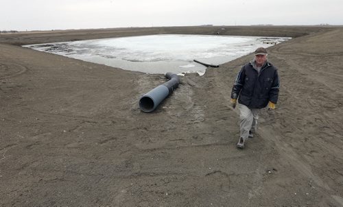Fannystelle, on Highway 2,   farmer  Curt Classen has built on-farm reservoir to hold phospherous-laden run-off from getting into Lake Wpg. Weep tile perferated plastic pipe is  put  in the field to drain water toward  the  holding reservoir , then pumped into main  resrvoir  as seen in background  .Story by Bill Redekop  .Ä®APRIL 23 2014 / KEN GIGLIOTTI / WINNIPEG FREE PRESS