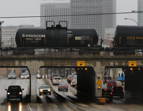 smaller older chemical rail cars travel through the city . LOCAL STDUP - New File for rail safety , chemical rail cars carrying hazardous materials through populated cities , many older cars will be taken out of service . Pic taken on Main St  at Sutherland  APRIL 24 2014 / KEN GIGLIOTTI / WINNIPEG FREE PRESS
