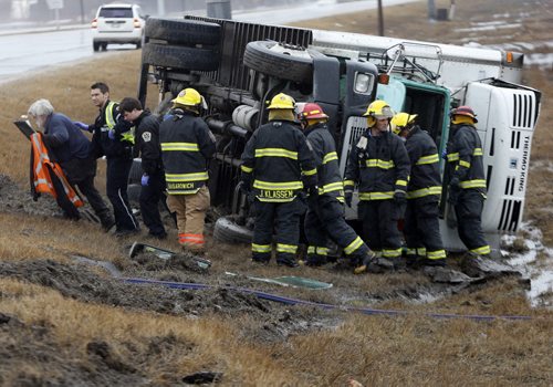 APRIL 24 2014 / KEN GIGLIOTTI / WINNIPEG FREE PRESS truck  rollover in the Perimeter Hwy east bound lane coming off the ram at Route 90 North , the truck hit the rain softened  shoulder  and turned over the driver had to extricated but had minor injuries , driver escorted by paramedics  fire  & crews to ambulance  APRIL 24 2014 / KEN GIGLIOTTI / WINNIPEG FREE PRESS