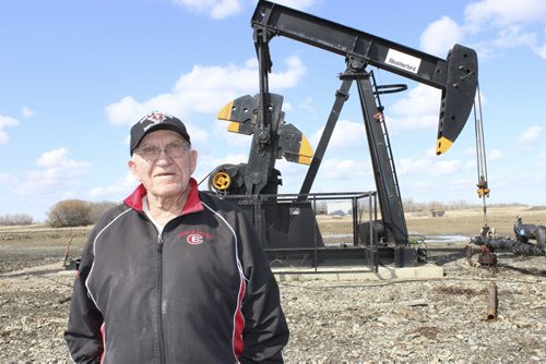 030 - Jake Sanheim and one of 17 new oil wells on his farm in the Manson Field. BILL REDEKOP/WINNIPEG FREE PRESS April 24,2014