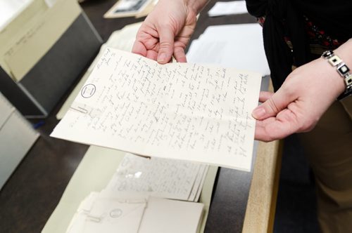 Kathleen Epp handles a World War 1 document at the Archive of Manitoba. Epp is putting together an exhibition of the World War 1 archives and they are currently requesting WW1 archival donations from Manitobans.  EMILY CUMMING / WINNIPEG FREE PRESS