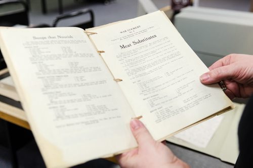 Kathleen Epp handles a World War 1 document at the Archive of Manitoba. Epp is putting together an exhibition of the World War 1 archives and they are currently requesting WW1 archival donations from Manitobans.  EMILY CUMMING / WINNIPEG FREE PRESS