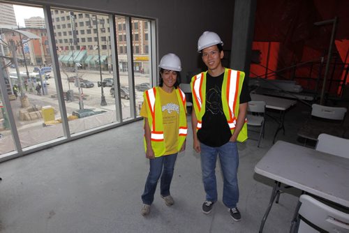 BIZ -Right, Thu Tran, Dev manager, and left, Kathy Chenglath, biz analyst. Photo taken in the future Winnipeg office of iQmetrix, a software development firm which is the second major tenant to lease office space in the Centrepoint office/restaurant complex. Theyre taking 10,000 square feet on the second floor facing out onto Portage Avenue, and hope to move into the space  in December of this year or early January of next year.. BORIS MINKEVICH / WINNIPEG FREE PRESS April 25, 2014