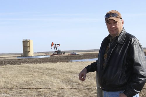 06 - 011 - Roger Wilson, reeve for the RM of Birtle, in front of an oil well in the Birdtail Field from which the RM receives monthly royalties. BILL REDEKOP/WINNIPEG FREE PRESS April 25,2014