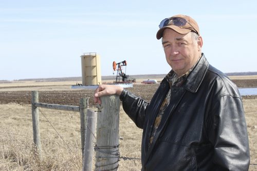 06 - 011 - Roger Wilson, reeve for the RM of Birtle, in front of an oil well in the Birdtail Field from which the RM receives monthly royalties. BILL REDEKOP/WINNIPEG FREE PRESS April 25,2014