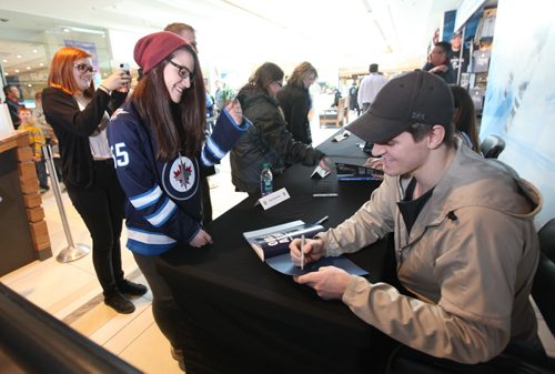 JETS FAVOURITE RECIPES -  Jets fan Megan Wray is all smiles while she gets her favourite Winnipeg  Mark Scheifele to sign her Jets recipe book at St. Vital Mall Saturday afternoon.  April 26, 2014 Ruth Bonneville / Winnipeg Free Pres