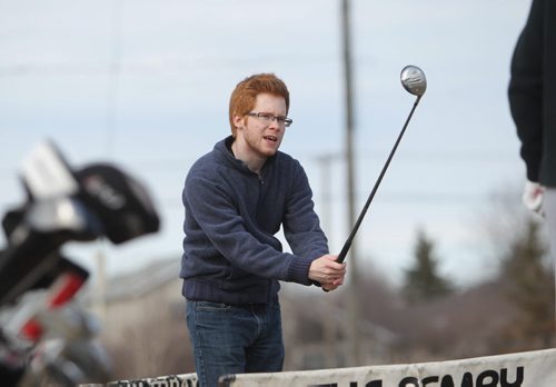 TJ Beggs enjoys his 1st time out with his golf clubs this year as he smacks some balls at Hackers and Smackers Driving Range in Charleswood Saturday afternoon.   April 26, 2014 Ruth Bonneville / Winnipeg Free Pres