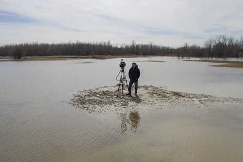 140427 Winnipeg - DAVID LIPNOWSKI / WINNIPEG FREE PRESS (April 27, 2014)  A CBC camera man sets up for a shot on a flooded residential property on Peguis First Nation Reserve Sunday April 27, 2014 as the Fisher River spills over its banks.
