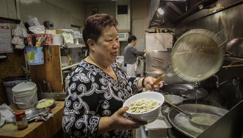 One of Winnipeg's iconic asian restaurants, Foon Hai, spent the last 53 days with frozen pipes. Employees are very happy that the business now has running water and the food orders were steady during the lunch hour. Manyuk Dare gets a bowl of noodles ready for a customer. 140428 - Monday, April 28, 2014 -  (MIKE DEAL / WINNIPEG FREE PRESS)