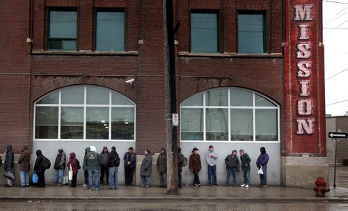 Some of Winnipeg's "street" people line up outside Siloam Mission Monday evening. April 28, 2014 - (Phil Hossack / Winnipeg Free Press)