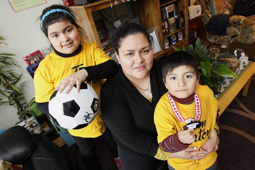 April 28, 2014 - 140428  - Elsa Garcia with her daughter Olivia and her son Diego are photographed in their home Monday, April 28, 2014. They participated in the Mobile Mini Soccer Program last year and they`re going again this year. The program brings coaches and premier players to four venues in Winnipeg`s inner city to teach kids how to play soccer. John Woods / Winnipeg Free Press