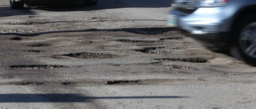 Somebody call 311   A nasty bunch of potholes have Winnipeg motorist with little choice but to drive through this cluster at Ferry Rd and Ness Ave Tuesday-Feature photo- Apr 29, 2014   (JOE BRYKSA / WINNIPEG FREE PRESS)