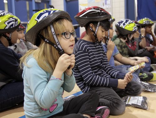 Jolene Clarke,7, and fellow students at Meadows West School received bicycle helmets and instruction how to wear them after the announcement Tuesday by Sharon Blady, Healthy Living and Seniors Minister the province will distribute 7,000 low cost bike helmets (900 helmets at no cost)  to children and youth. The Low-Cost Bike Helmet Initiative has distributed more than 97,000 helmets since 2006. see release.   Larry Kusch story   Wayne Glowacki / Winnipeg Free Press April 29   2014