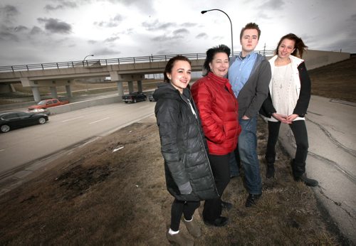 Karen Tarasca Alcock and her kids (left to right Christina, Matt and Sarah)  with the Kenaston Underpass in the background. She is running for the federal Liberal nomination on the riding where the city is naming that stretch of road after her late husband and Liberal MP Reg Alcock. April 30, 2-14 - (Phil Hossack / Winnipeg Free Press)