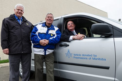 Grand Master Doug Webster (left), Ken Butchart and Grand Secretary Ted Jones gather around a van donated by the Freemasons of Manitoba to the Canadian Cancer Society.  With the Freemasons Cancer Car Program, Freemasons volunteer their time to drive cancer patients to receive treatment.  EMILY CUMMING / WINNIPEG FREE PRESS