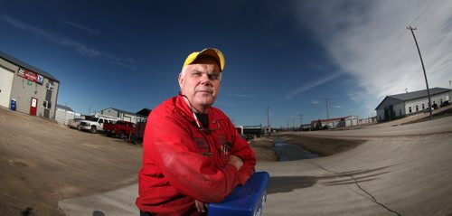 Former Plymouth Bretheren member Phil Admiral poses outside his Stonewall auto repair business in the community's Business Park. Ironically several of the businesses now surrounding his are owned by Bretheren. May 1, 2014 - (Phil Hossack / Winnipeg Free Press)