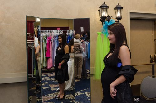 Shannon Keesickquayash, 18, poses as her grandmother takes her photo at the Gowns for Grads program held at the convention centre.  The Gowns for Grads is a volunteer program that provides used and new dresses for graduation.  EMILY CUMMING / WINNIPEG FREE PRESS