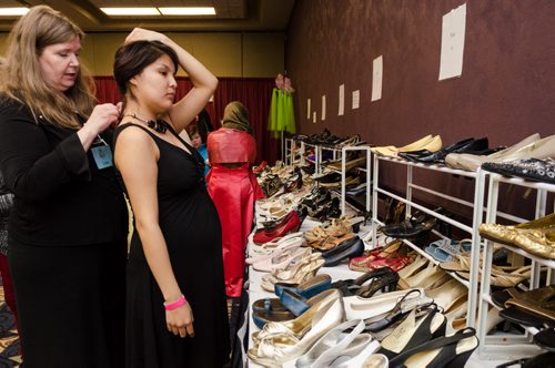 Shannon Keesickquayash, 18, tries on a necklace at the Gowns for Grads program held at the convention centre.  Gowns for Grads is a volunteer program provides used and new dresses for graduation.  EMILY CUMMING / WINNIPEG FREE PRESS