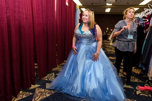Julie Syganiec tries on a dress at the Gowns for Grads program.  Gowns for Grads is a volunteer program that provides used and new dresses for graduation.  EMILY CUMMING / WINNIPEG FREE PRESS